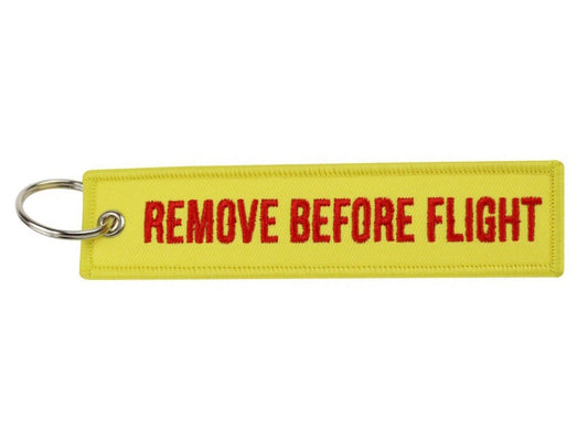 Remove Before Flight gul med rød tekst